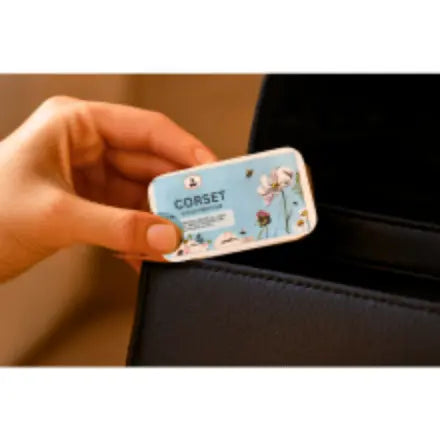 Hand holding a Corset Solid perfume to put in a handbag