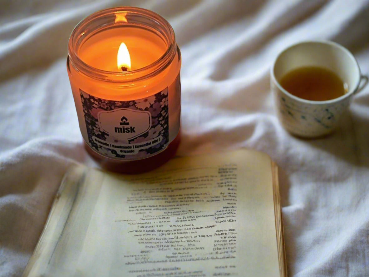 Lavender candle styled with herbal tea and journal for a relaxing bedtime mood