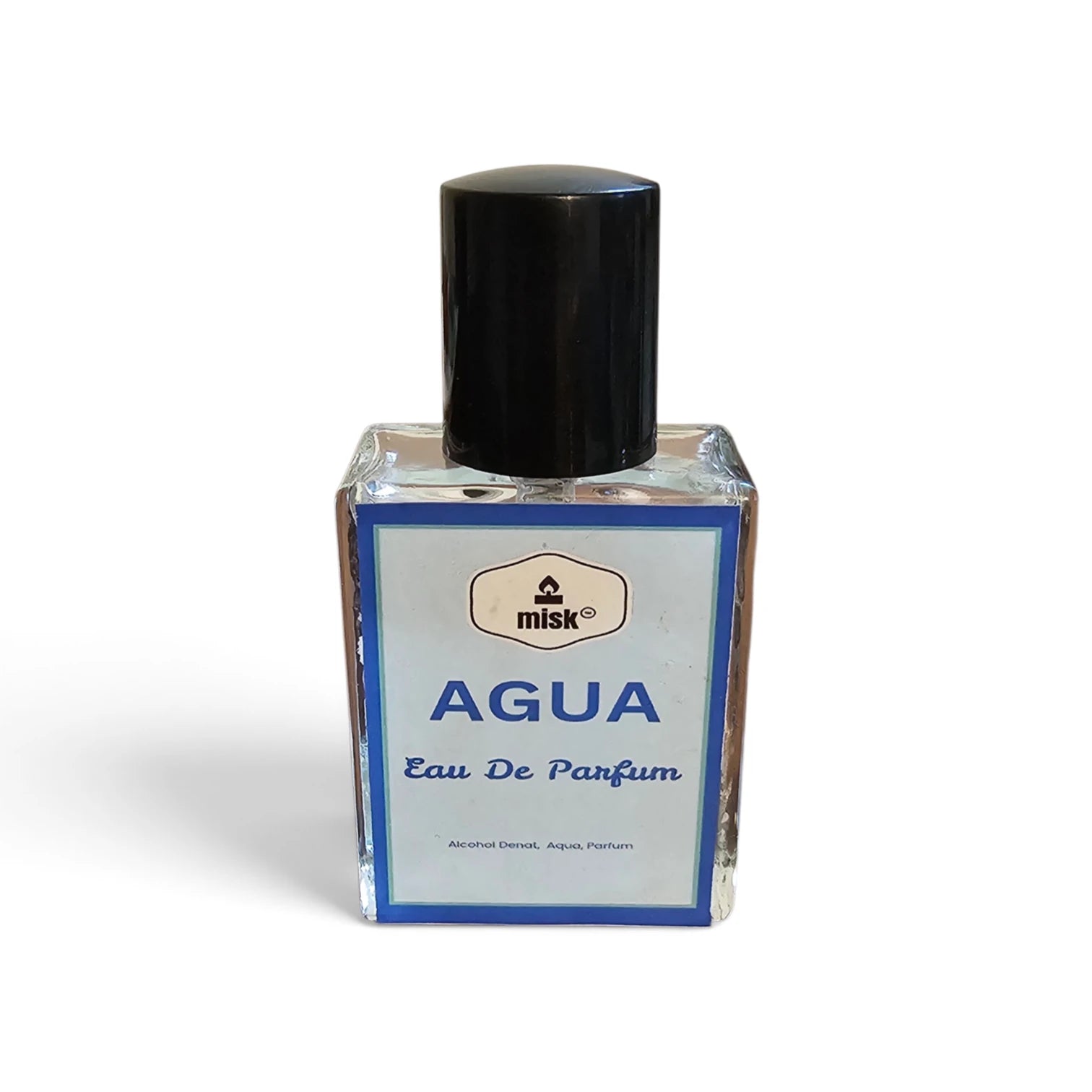 A small rectangular glass perfume bottle labeled 'misk AGUA Eau De Parfum' with a black cap, set against a plain white background.