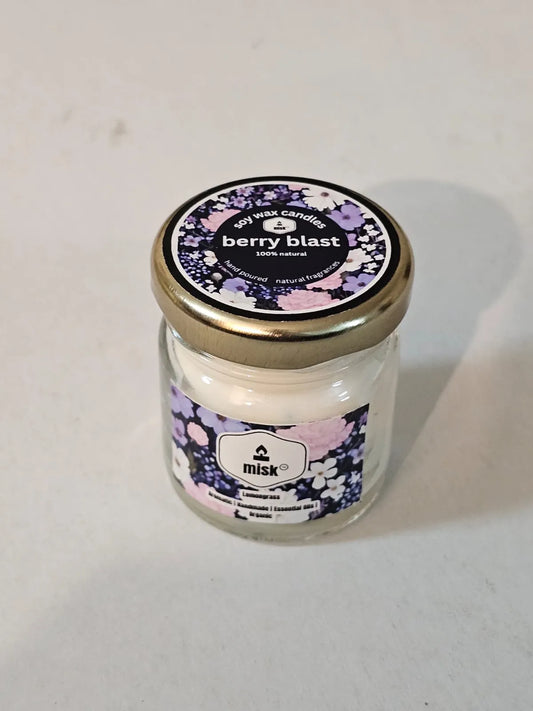 Candle jar labeled 'berry blast' with a decorative label on a white background