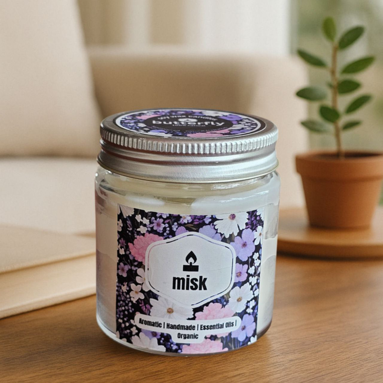 misk Butterfly soy wax candle with jasmine, rose, vanilla notes in a floral jar