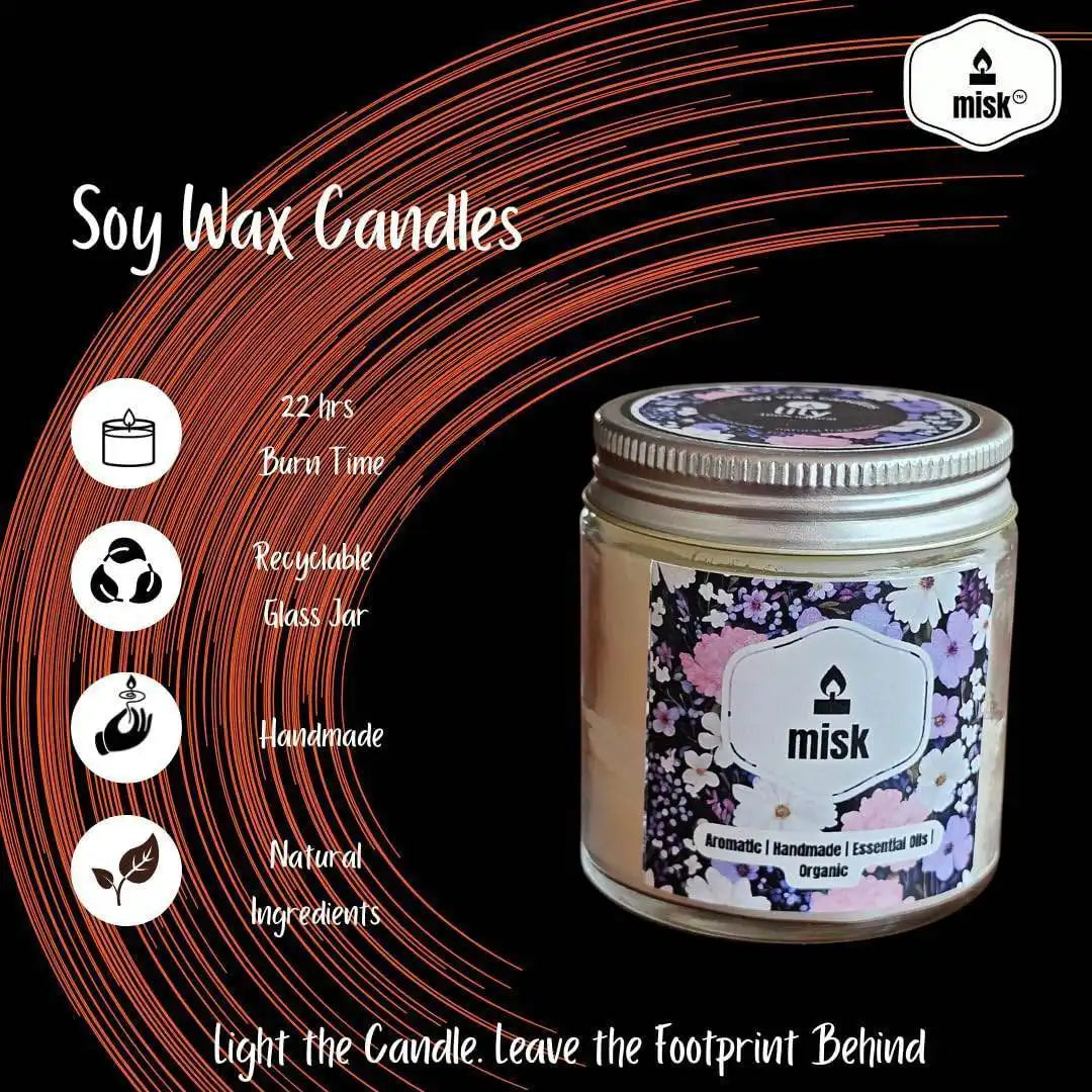 Soy wax candle with floral label and 'misk' branding on a black background
