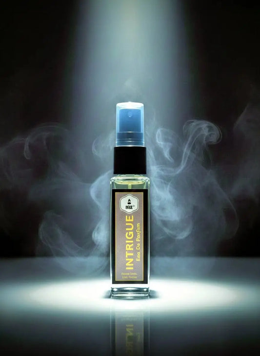 Bottle of Intrigue perfume with smoke effect on a dark background