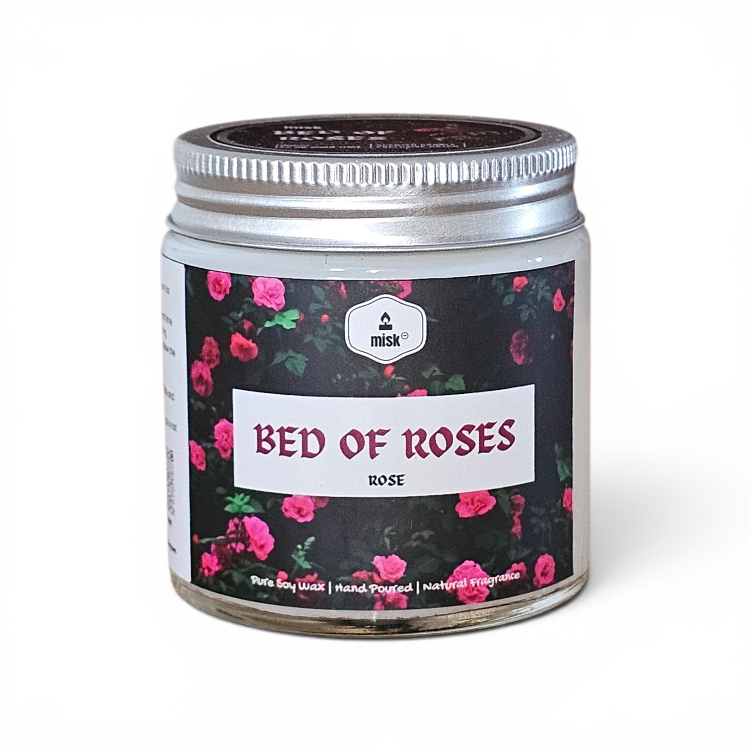 Candle jar labeled 'Bed of Roses' with floral design on a white background