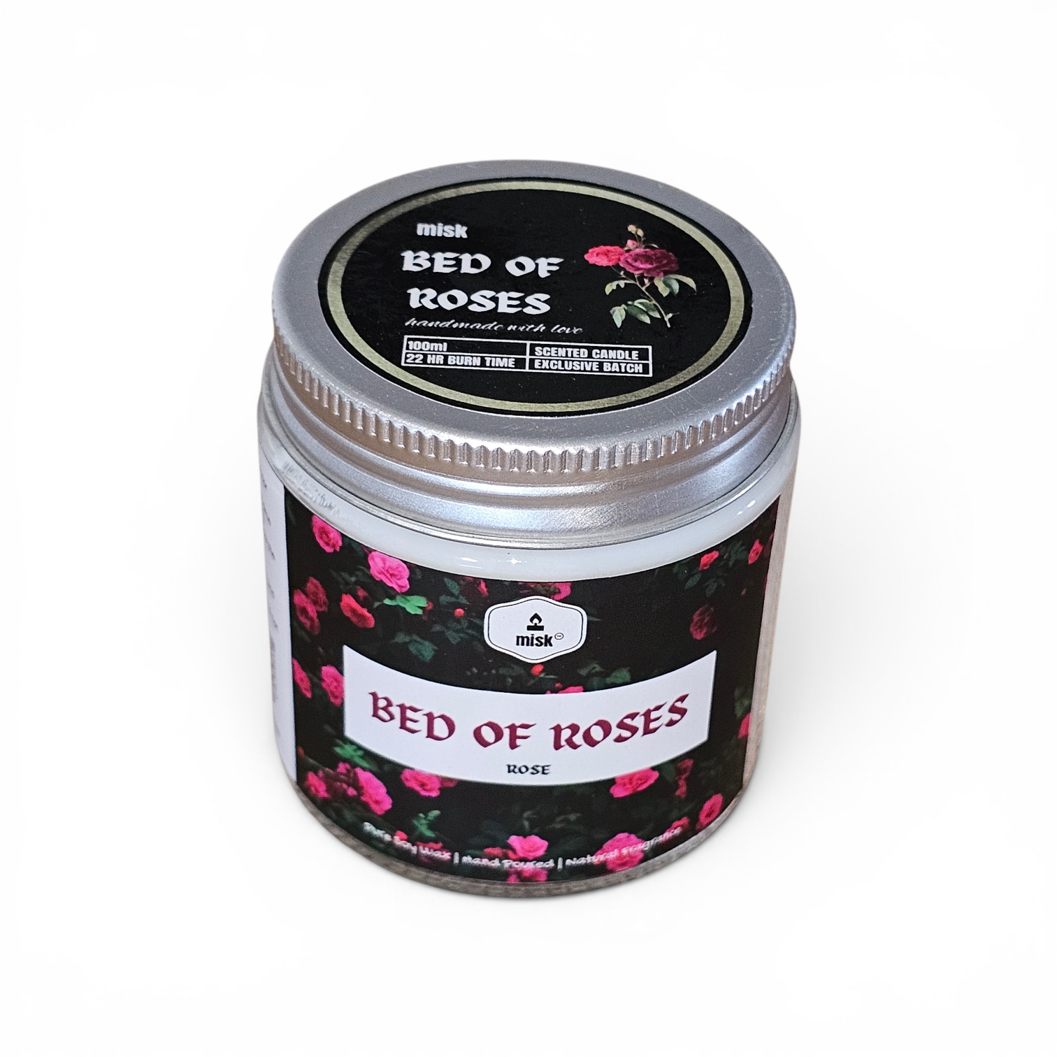 Jar of 'Bed of Roses' candle with floral design on a white background